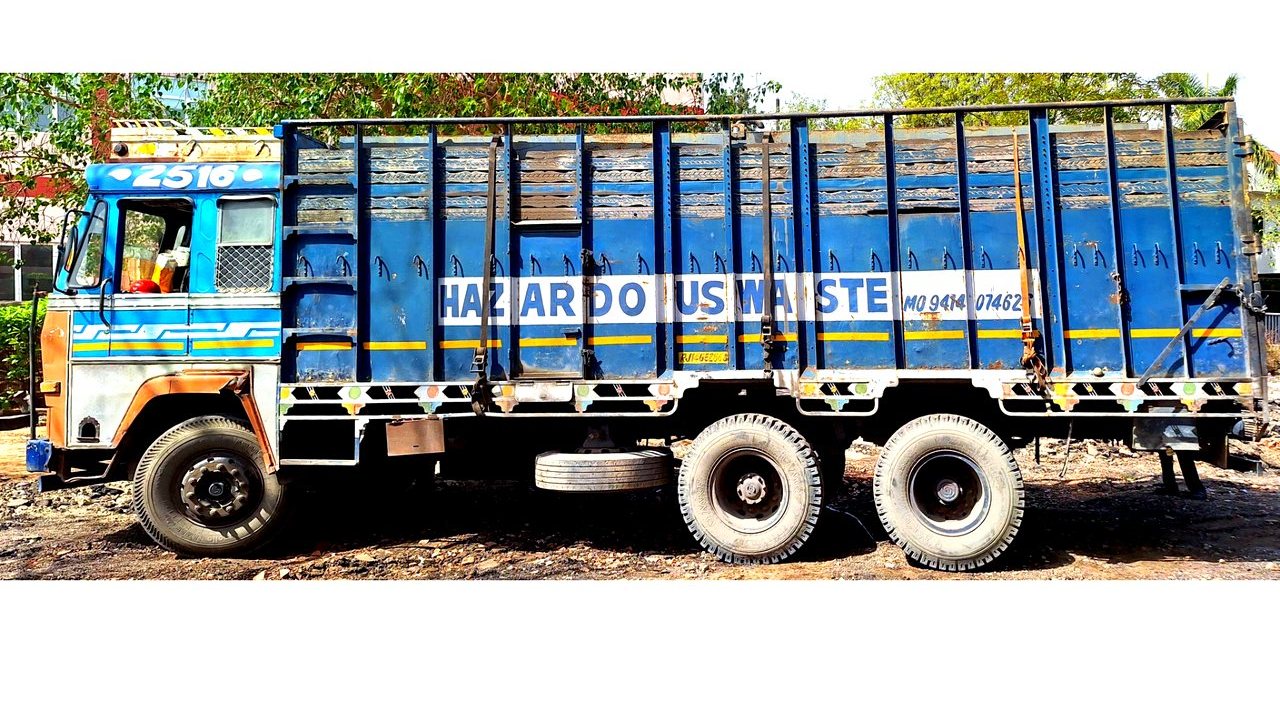 BIOCIL actual RPCB-authorized hazardous waste truck — blue Ashok Leyland with HAZARDOUS WASTE marking